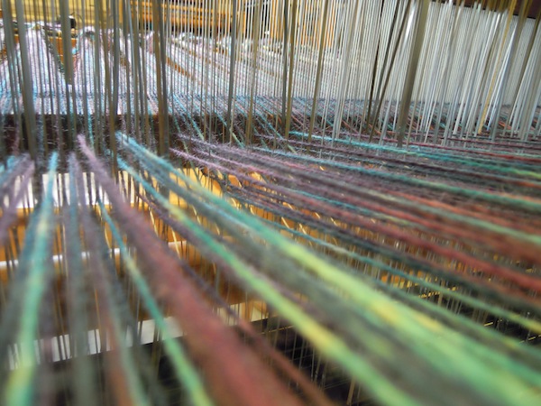 Heddles being threaded