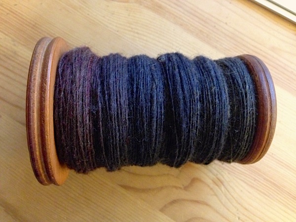 My full bobbin of beautiful hand painted roving, spun into a single ply yarn.