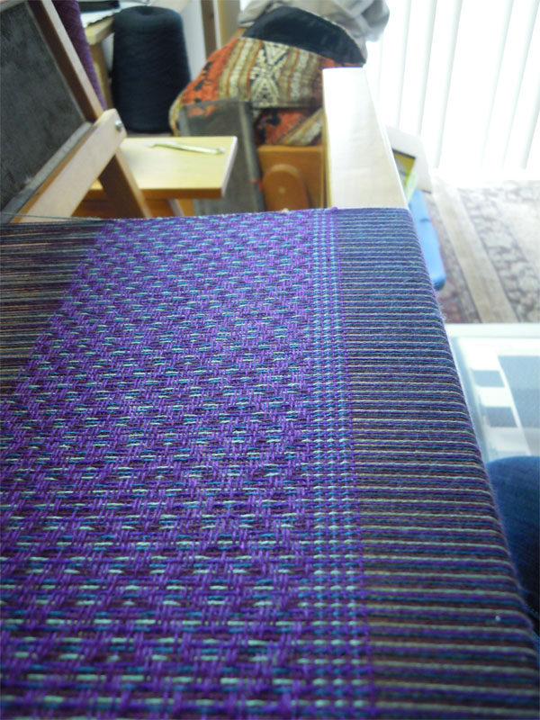 Purple scarf on loom.