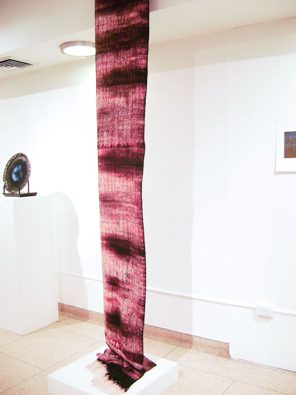 The same weaving on display in an exhibition of student work.