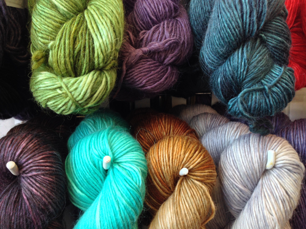 Beautiful single ply yarns hung in skeins.